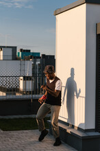 Cheerful Black Guy Dancing On Rooftop