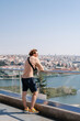 © Alina Hvostikova/Stocksy - Man admiring river in city
