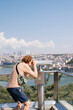 © Alina Hvostikova/Stocksy - Male tourist admiring city through binoculars