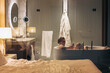 © Alina Hvostikova/Stocksy - Man using smartphone in bathtub in hotel
