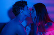 © Alina Hvostikova/Stocksy - Tender couple kissing in neon lights
