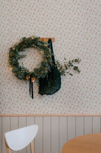 Christmas Wreath And Bag Hanging On Wall