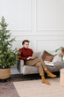 © Alina Hvostikova/Stocksy - Focused guy working remotely on laptop during Christmas holidays at home