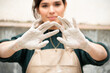 © Malquerida Studio/Stocksy - Close up of a young ceramist woman with  hands dirty of clay