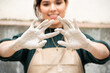 © Malquerida Studio/Stocksy - Close up of a young ceramist woman looking her hands dirty of clay