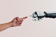 © Don Smith/Stocksy - Human and robot hands touch fingers