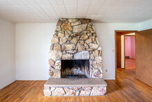 A Typical Stone Surround On A Wood Burning Fireplace In An Empty Mid Century Home.
