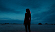 © Ibai Acevedo/Stocksy - Girl silhouette standing in a dark sunset