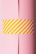 © Kristin Duvall/Stocksy - Orange striped tape on pink