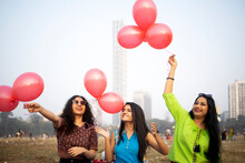 Indian Girls Making Fun With Balloons At Outdoors