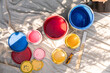© Jayme Burrows/Stocksy - Colorful Paint Cans Sitting On A Tarp Outdoors
