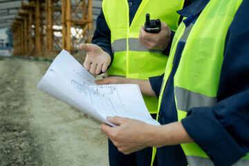 Poster - Hands of male builder explaining sketch to female colleague at working meeting