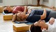 © Danil Nevsky/Stocksy - Group o women meditating during yoga lesson