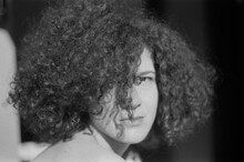 A Black And White Portrait Of A Beautiful Curly Woman