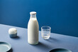 © Martí Sans/Stocksy - Bottle of milk near container and glass