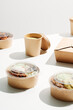 © Martí Sans/Stocksy - Cup of coffee and food in cardboard containers