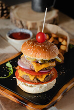 Mouth-Watering Burger On Wooden Board.