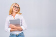 © denis_vermenko - Image of cheerful mature business woman standing isolated over white background using laptop computer. Portrait of a smiling senior lady holding laptop computer.