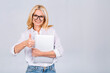 © denis_vermenko - Image of cheerful mature business woman standing isolated over white background using laptop computer. Portrait of a smiling senior lady holding laptop computer. Thumbs up.