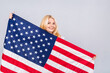 © denis_vermenko - Smiling senior beautiful patriotic woman wearing united states flag isolated over white background with a surprise face.