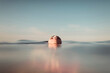 © Ibai Acevedo/Stocksy - Floating female face in the middle of the sea