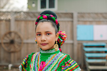 Portrait Of A Mexican-American Girl Dressed Up With A Traditional Mexican Dress