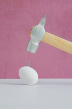 An Egg With Nail And Hammer