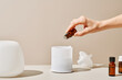 © Martí Sans/Stocksy - Crop person preparing aromatic liquid for diffuser