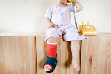 Close Up Of A Toddler With A Cast