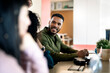 © Santi Nuñez/Stocksy - Multiethnic Coworkers Working Together in Office