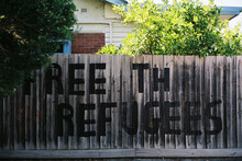 FREE THE REFUGEES Painted On Fence In Australian Suburb