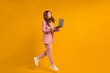 © alfa27 - Excited jumping woman with laptop isolated on yellow studio background. Modern technologies, freedom of choices concept, emotions concept. Using laptop for work and fun in flight.