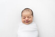 © Alison Winterroth/Stocksy - A baby smiling in her sleep
