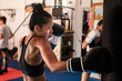 © Irina Efremova/Stocksy - Thai Female Muay Thai Athlete Performing Hook On The Heavy Bag