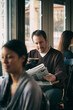 © Sean Locke/Stocksy - Cafe: Man Reads Paper While Having Cup Of Coffee