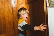 A toddler hiding in a closet