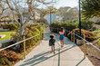 © Erin Brant/Stocksy - Sisters running on sidewalk