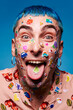 © Studio Marmellata/Stocksy - Expressive man with stickers on face in studio