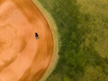 A Tractor Raking A Baseball Field 