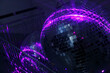© Danil Nevsky/Stocksy - Shiny disco balls in neon lights
