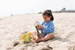 © Valentina Barreto/Stocksy - child playing in the sand