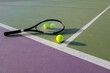 © Bisual Studio/Stocksy - Tennis racket and ball on a colorful court
