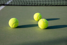 Tennis Balls On Green And Purple Court 