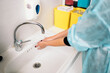 © Santi Nuñez/Stocksy - Unrecognizable Doctor Washing Hands Before work