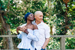 © ByLorena/Stocksy - Happy diverse couple standing in embrace on terrace