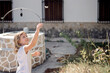 © Albert Martinez/Stocksy - Kid playing with butterflies outside of a house