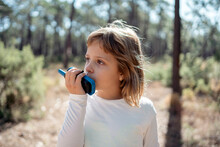 Girl Talking With A Walkie Talkie In The Forest