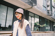 © Pansfun Images/Stocksy - young women with hat and glasses in the street