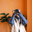 © Pansfun Images/Stocksy - Young Asian female photographer holding camera