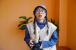 © Pansfun Images/Stocksy - Young Asian female photographer holding camera